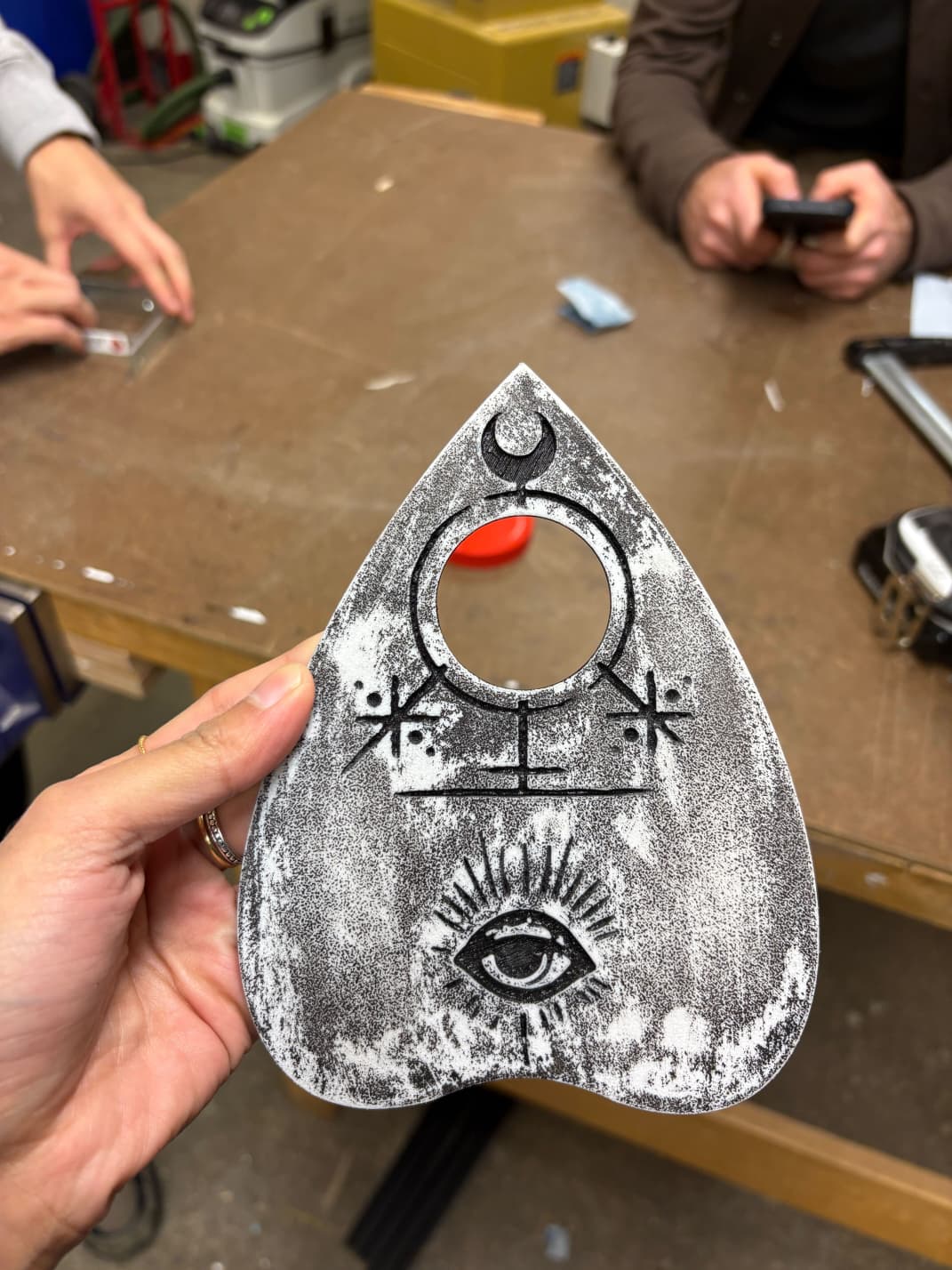 Finished Ouija planchette with engraved eye and symbols